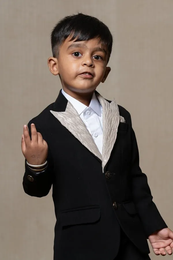 Classic black blazer with a champagne metallic-textured lapel, paired with matching pants and a crisp white shirt for a sophisticated formal look